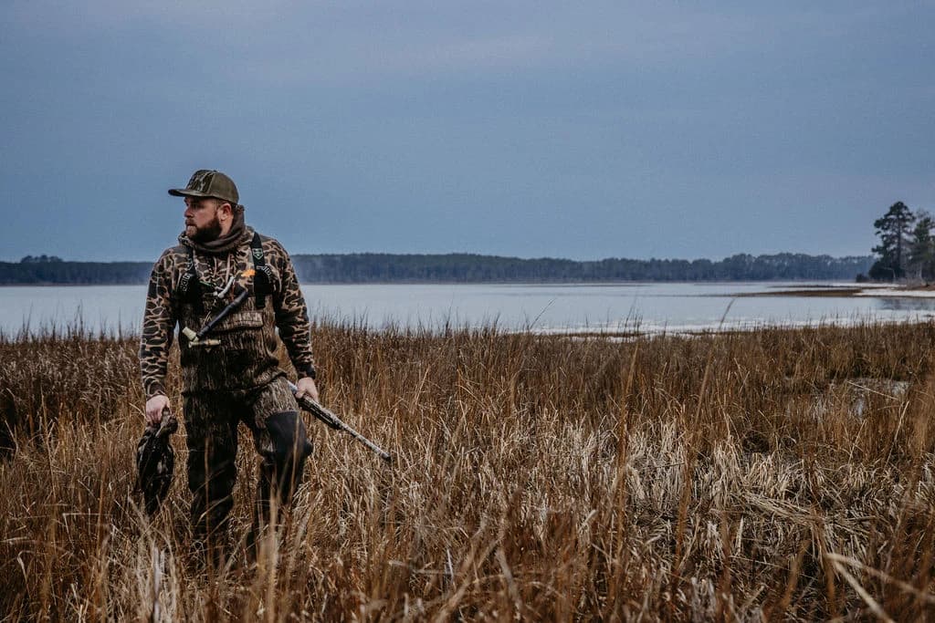 Solo hunter crossing the marsh