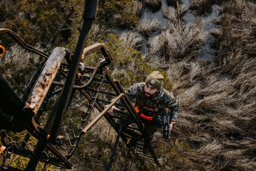 Hunter climbing into a treestand