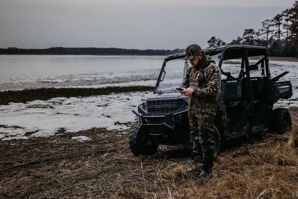 Checking the phone beside the Polaris