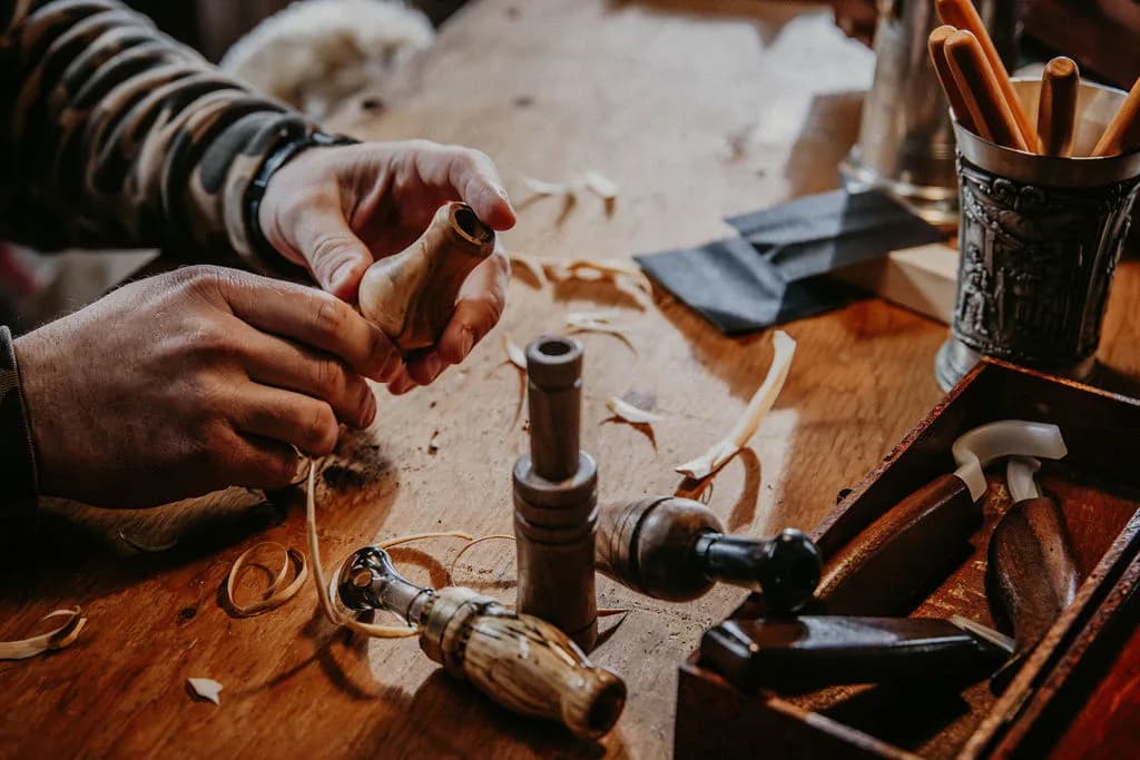 Hands holding a freshly turned game call