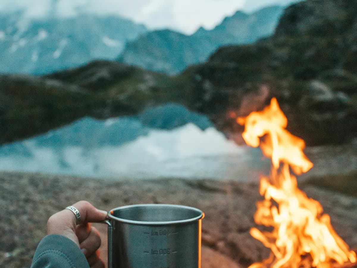 Campfire coffee mug by a lake